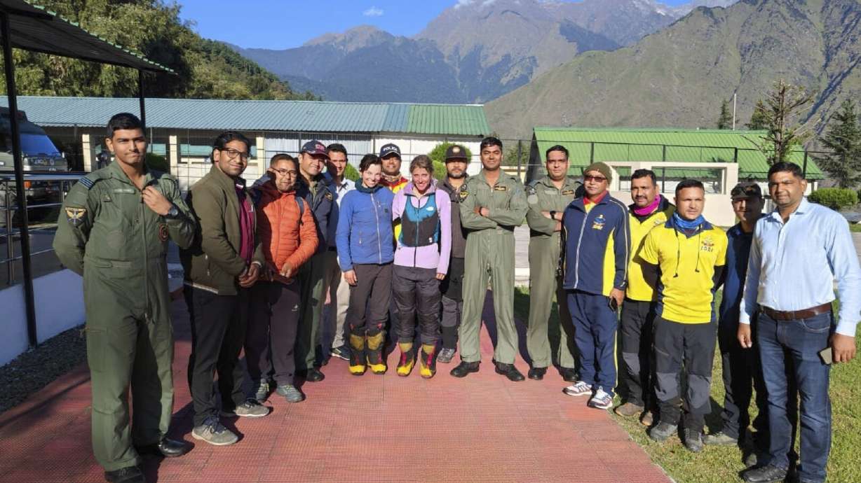 This photograph shared by Indian Air Force on the X platform shows two foreign climbers, center, who were stranded in India's Himalayas posing with Indian Air Force personnel who rescued them in Uttarakhand, India, Monday, Oct. 7, 2024.