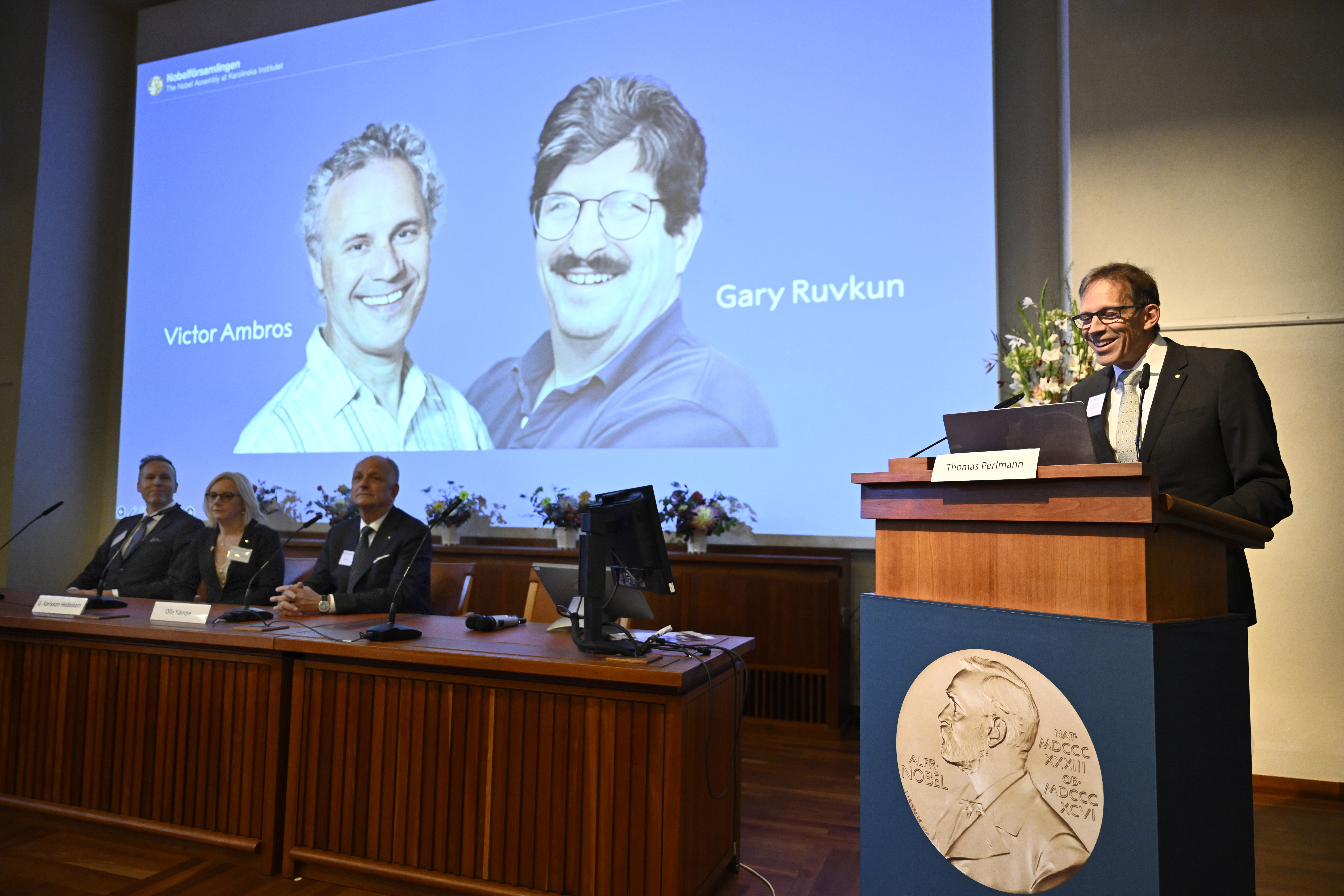 Nobel Committee chairman Thomas Perlmann, right, announces Americans Victor Ambros and Gary Ruvkun, for this year's Nobel Prize in Physiology or Medicine, during a press conference at the Karolinska Institute in Stockholm, Sweden, on Monday.