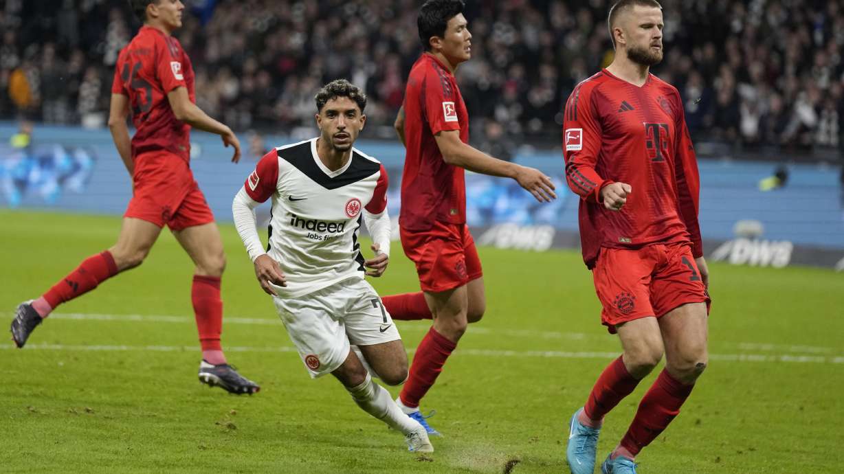 Frankfurt's Omar Marmoush, centre, celebrates after scoring his side's third goal during the German Bundesliga soccer match between Eintracht Frankfurt and Bayern Munich in Frankfurt, Germany, Sunday, Oct. 6, 2024.