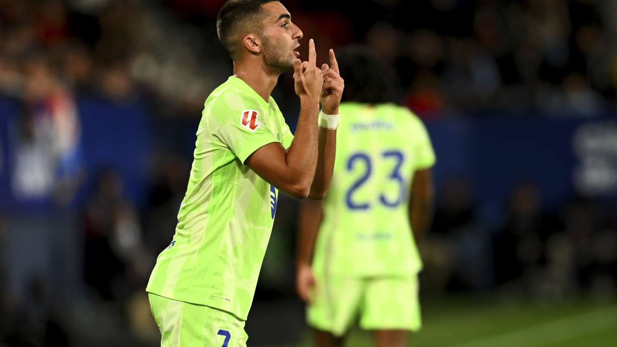 Barcelona's Ferran Torres reatcs during a Spanish La Liga soccer match between Osasuna and Barcelona at El Sadar stadium in Pamplona, Spain, Saturday, Sept. 28, 2024.