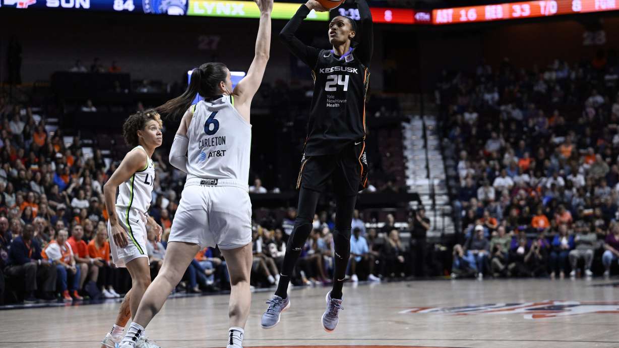Connecticut Sun forward DeWanna Bonner (24) shoots over Minnesota Lynx forward Bridget Carleton (6) during the second half of Game 4 in the WNBA basketball semifinals, Sunday, Oct. 6, 2024, in Uncasville, Conn.