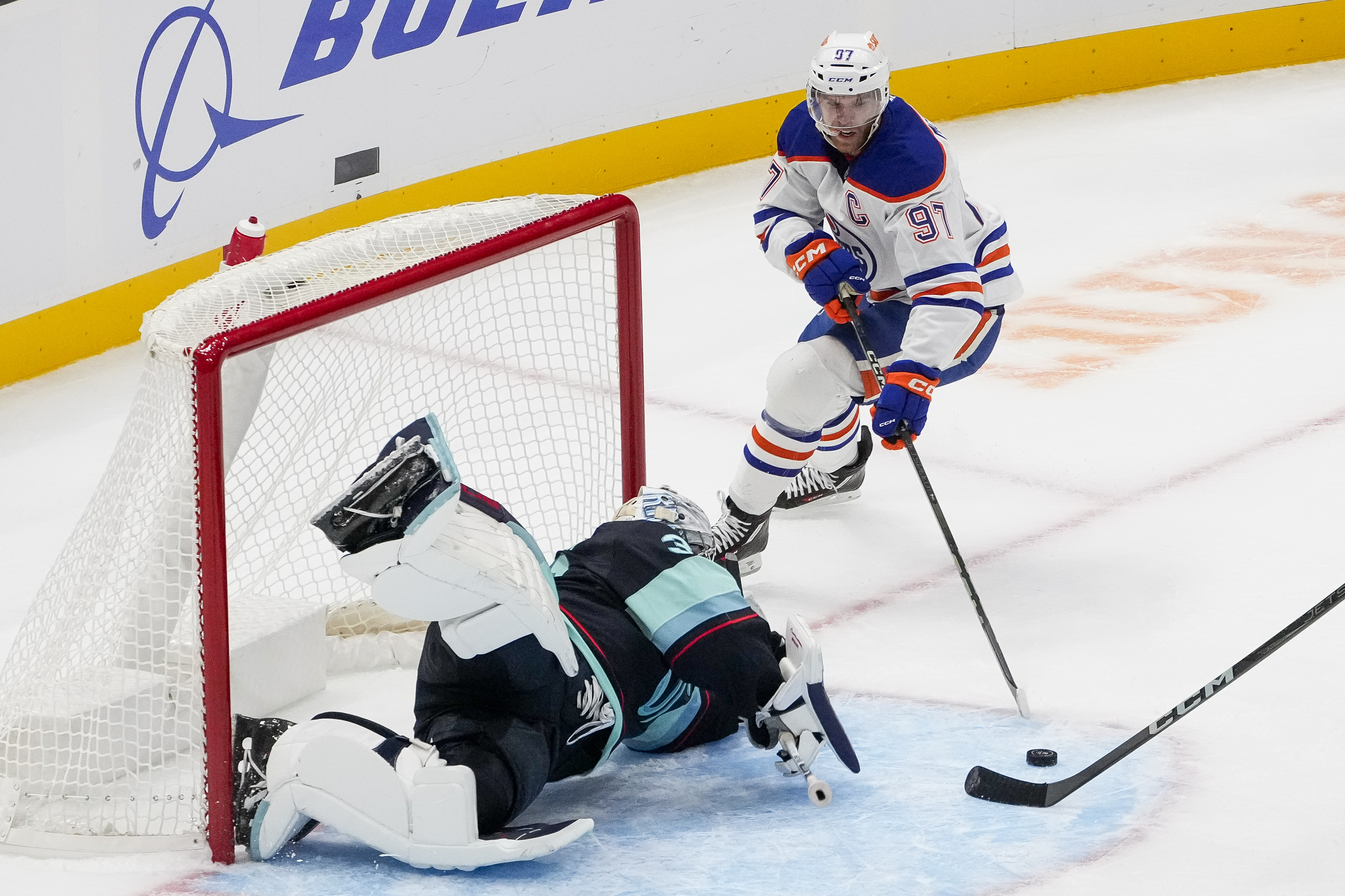 Seattle Kraken goaltender Philipp Grubauer makes a save against Edmonton Oilers center Connor McDavid (97) during the first period of a preseason NHL hockey game Wednesday, Oct. 2, 2024, in Seattle.