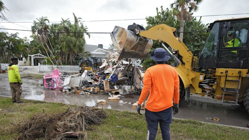 Salvage works remove debris from Hurricane Helene flooding along the Gulf of Mexico Monday in Clearwater Beach, Fla. Crews are working to remove the debris before Hurricane Milton approaches Florida's west coast.