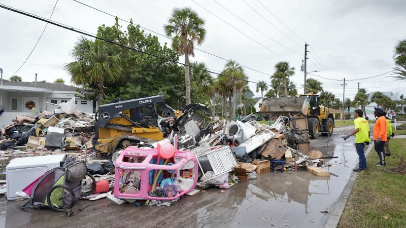 Salvage works remove debris from Hurricane Helene flooding along the Gulf of Mexico Monday in Clearwater Beach, Fla. Crews are working to remove the debris before Hurricane Milton approaches Florida's west coast.