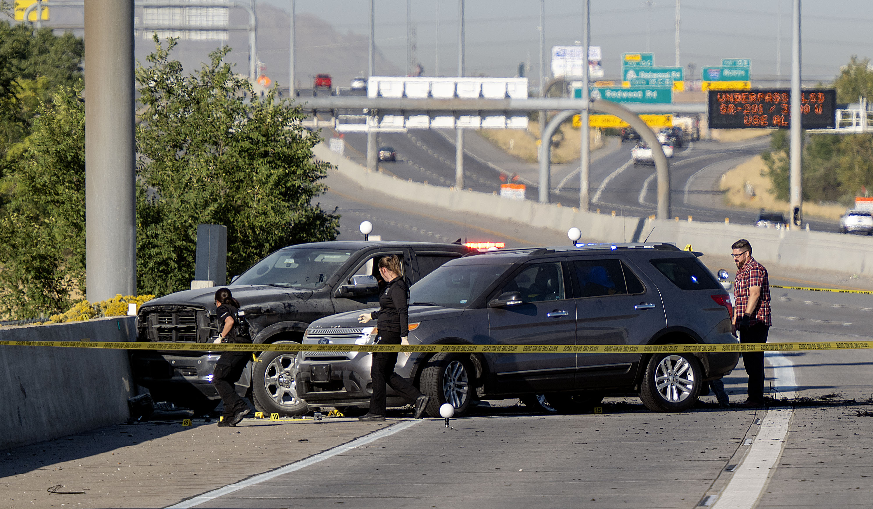 Officers investigate after a fatal road rage shooting on state Route 201 near 1000 West in Salt Lake City on Oct. 7. A Salt Lake man was charged Thursday with murder and accused of killing a driver while he was still wearing his seat belt.