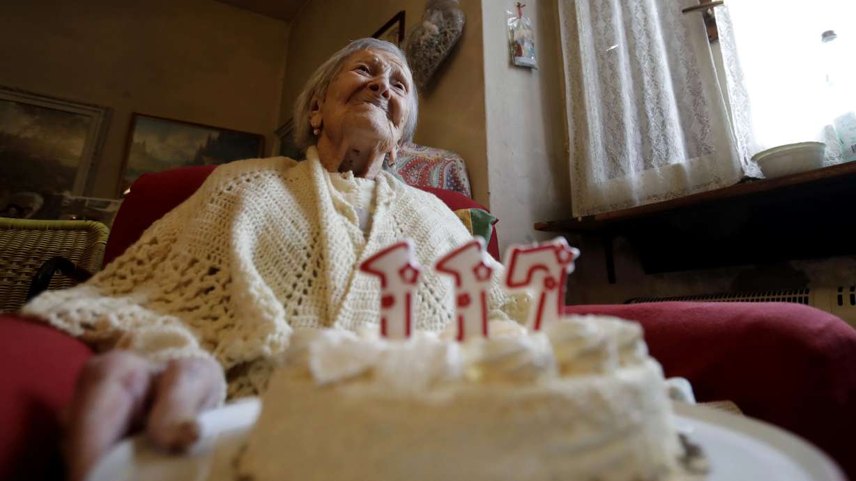 Emma Morano holds a cake with candles marking 117 years on the day of her birthday, Nov. 29, 2016, in Verbania, Italy. A new study suggests that humanity is hitting the upper limit of life expectancy.