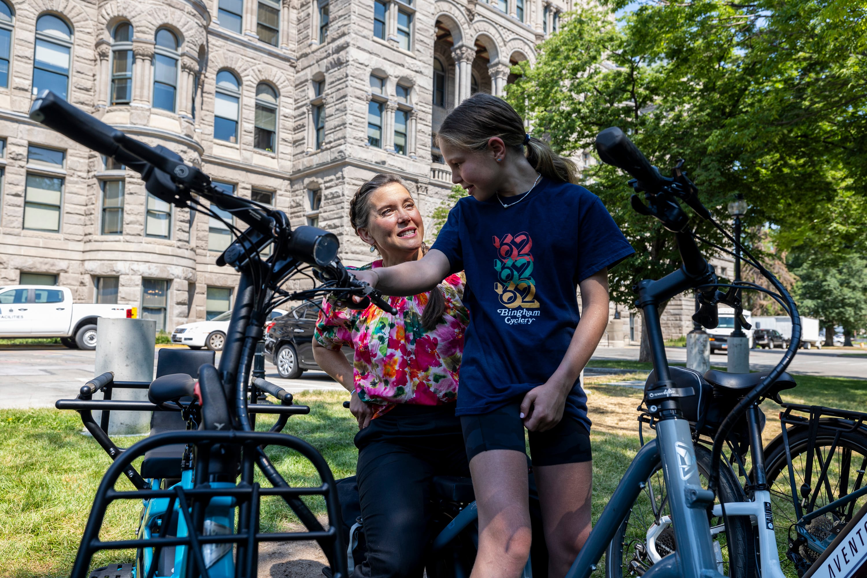 Salt Lake City Mayor Erin Mendenhall talks about bikes with Eva Thornton, 11, of Salt Lake City, in Washington Square Park in Salt Lake City on July 9. Fewer 16-year-olds are getting their driver's licenses, a report finds. 