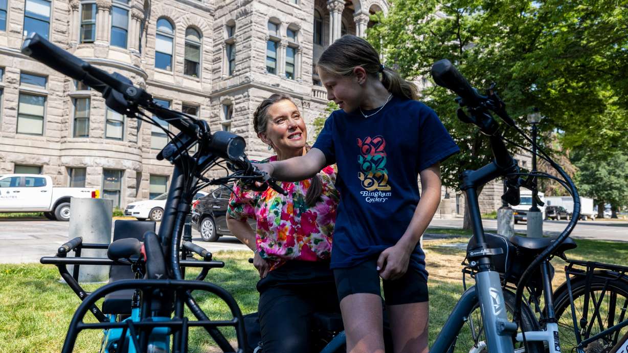 Salt Lake City Mayor Erin Mendenhall talks about bikes with Eva Thornton, 11, of Salt Lake City, in Washington Square Park in Salt Lake City on July 9. Fewer 16-year-olds are getting their driver's licenses, a report finds.