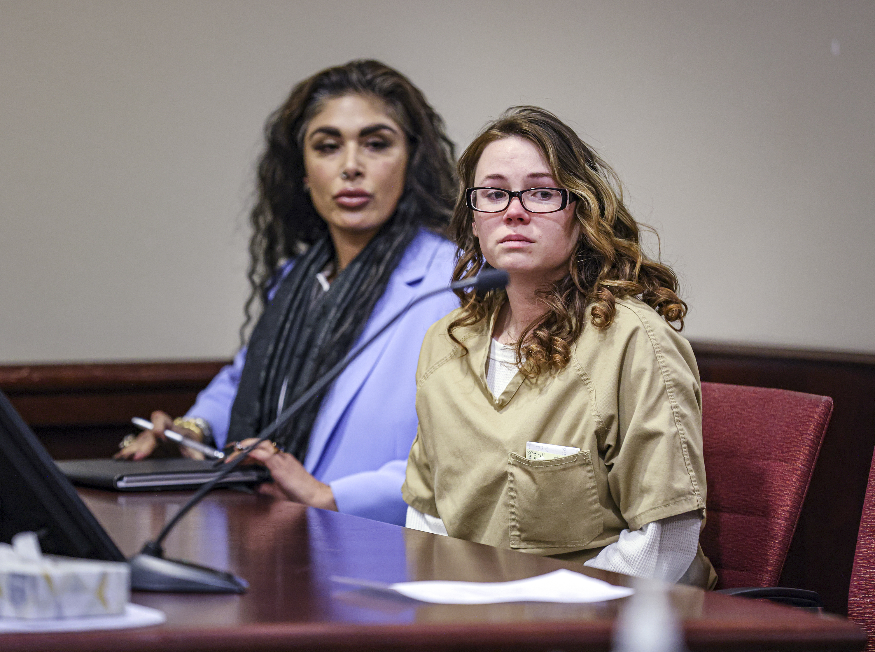 Hannah Gutierrez-Reed, the weapons supervisor on the set of the Western film “Rust," right, sits beside paralegal Carmella Sisneros during her plea hearing in Santa Fe, N.M., Monday. Gutierrez-Reed pleaded guilty to carrying a gun into a license liquor establishment.