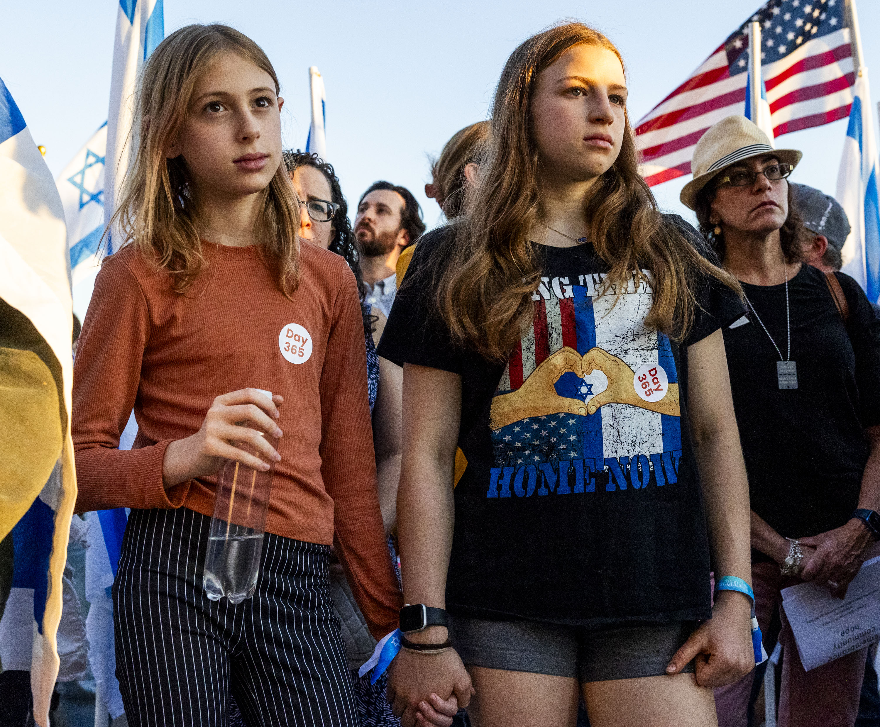 Cousins Noa Keren, right, and Yally Keren hold hands during a prayer at a memorial to mark the one-year anniversary of the Oct. 7, 2023, attack on Israel by Hamas, at the state Capitol in Salt Lake City on Monday.