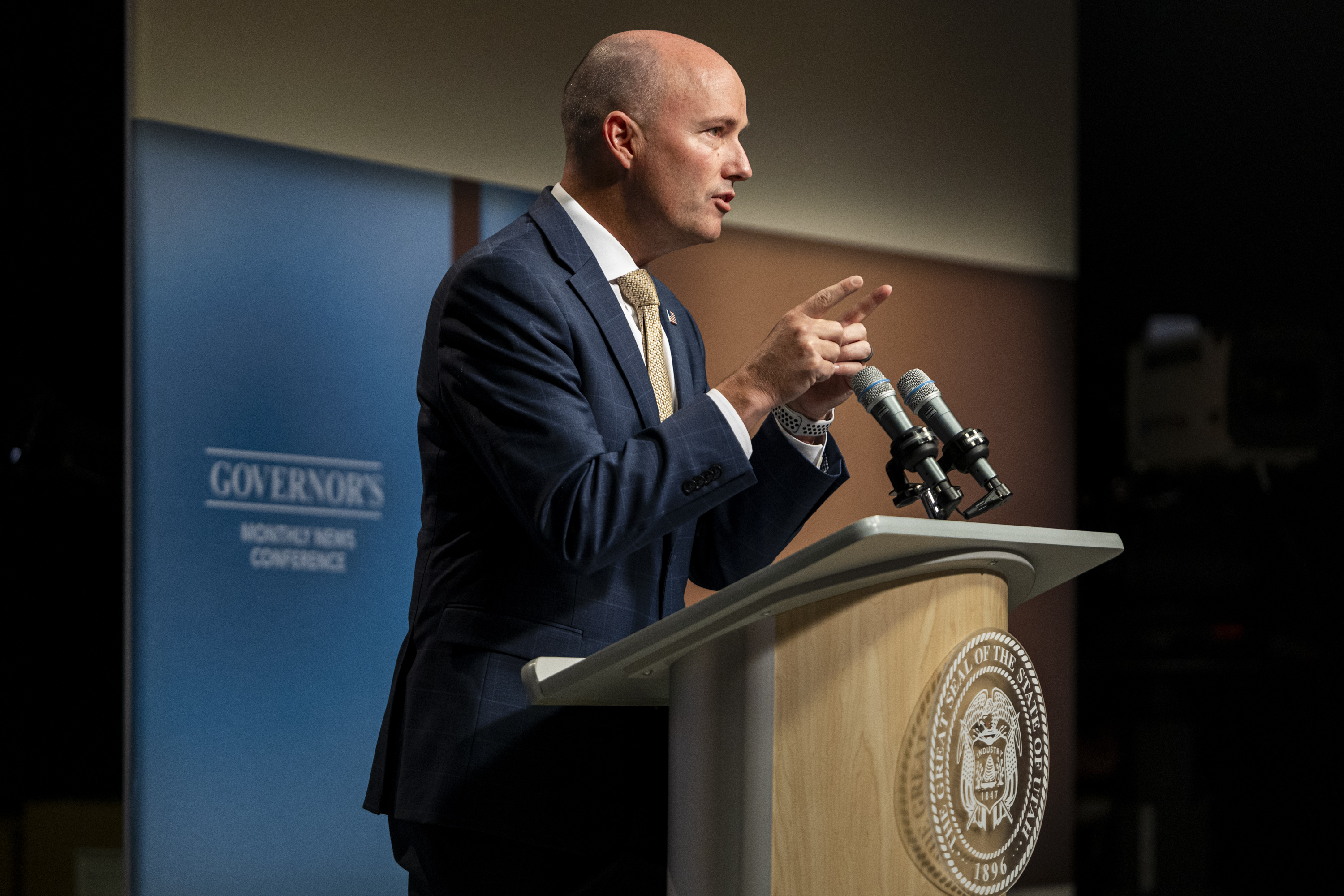 Utah Gov. Spencer Cox speaks at his monthly news conference in Salt Lake City on Sept. 19. Cox and 24 other governors are pressing the Biden administration for details on Venezuelan, Haitian and other parolees allowed into the country.