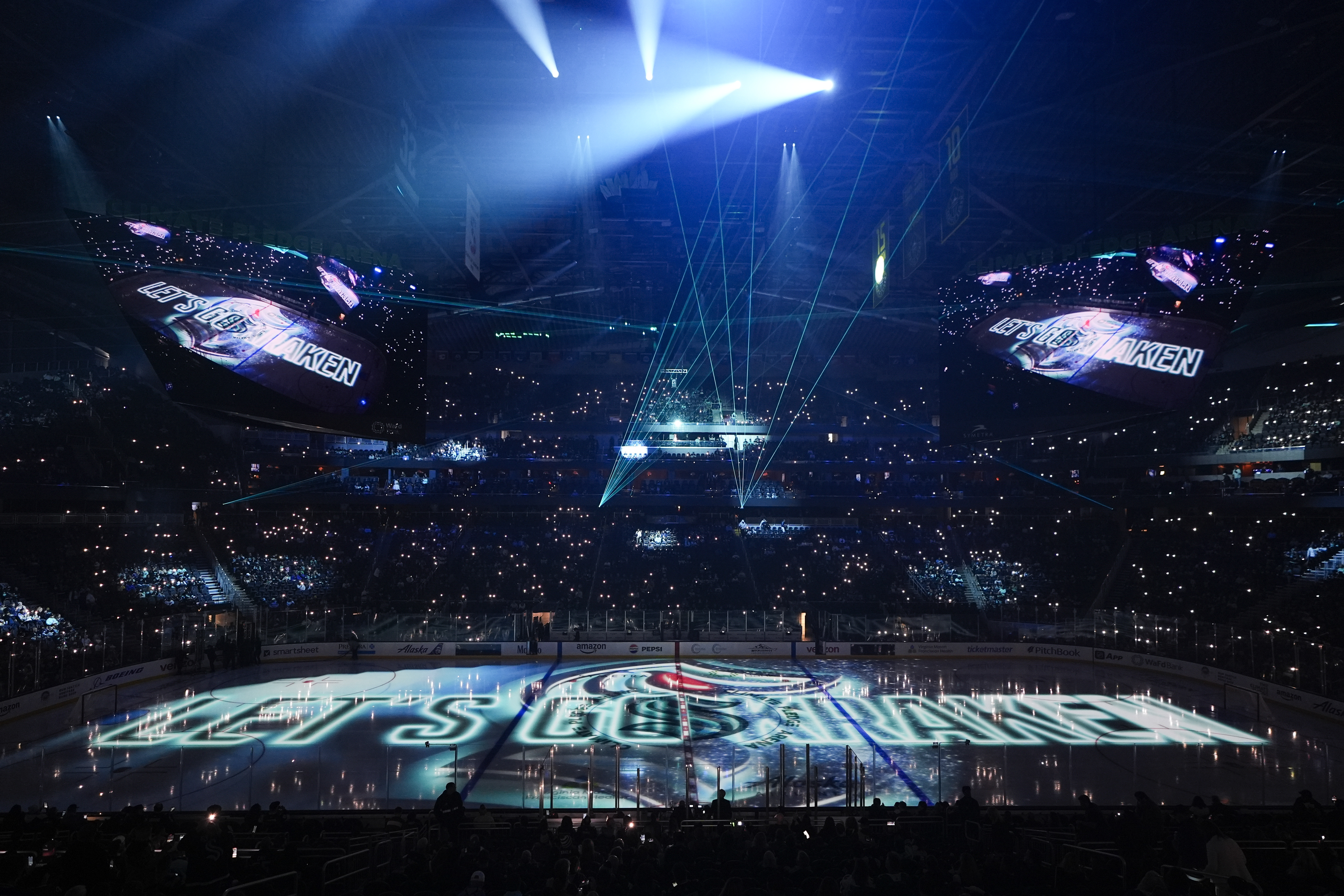 Pregame lights and lasers flash before an NHL hockey game between the Seattle Kraken and the St. Louis Blues, Tuesday, Oct. 8, 2024, in Seattle.