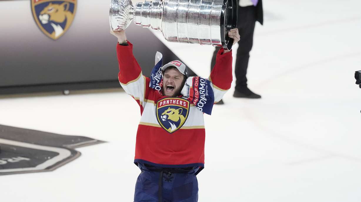 FILE - Florida Panthers center Aleksander Barkov (16) lifts the Stanley Cup trophy after Game 7 of the NHL hockey Stanley Cup Final, on June 24, 2024, in Sunrise, Fla.