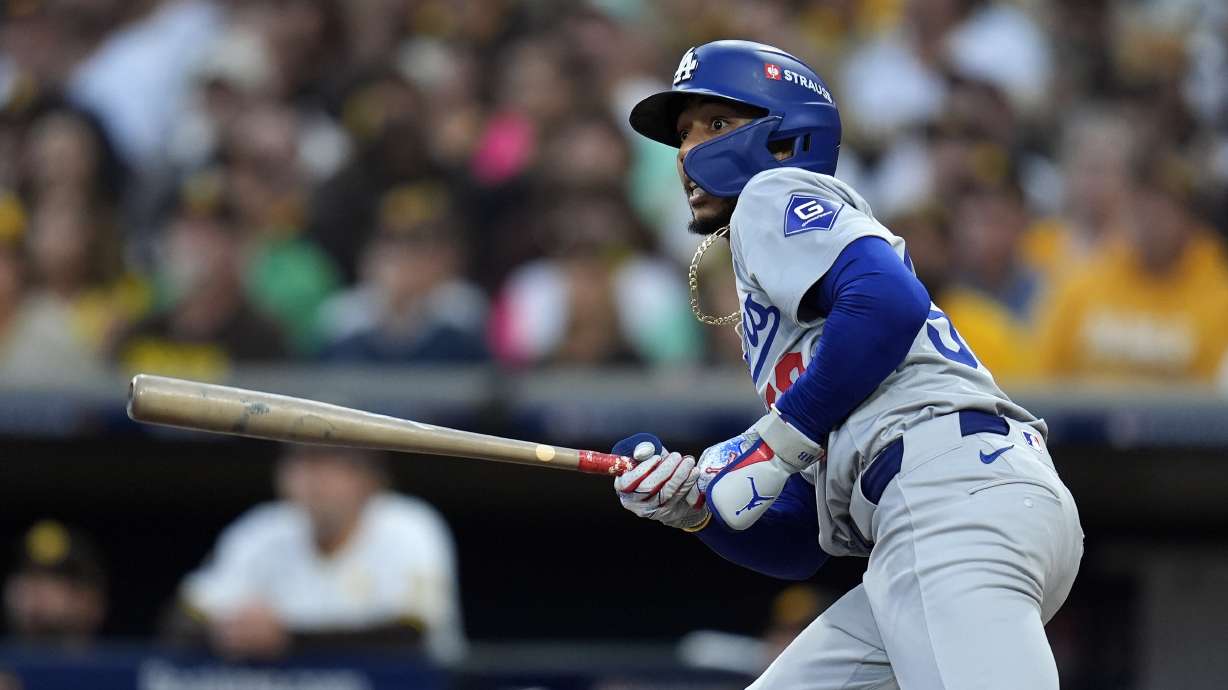 Los Angeles Dodgers' Mookie Betts watches his solo home run during the first inning in Game 3 of a baseball NL Division Series against the San Diego Padres, Tuesday, Oct. 8, 2024, in San Diego.