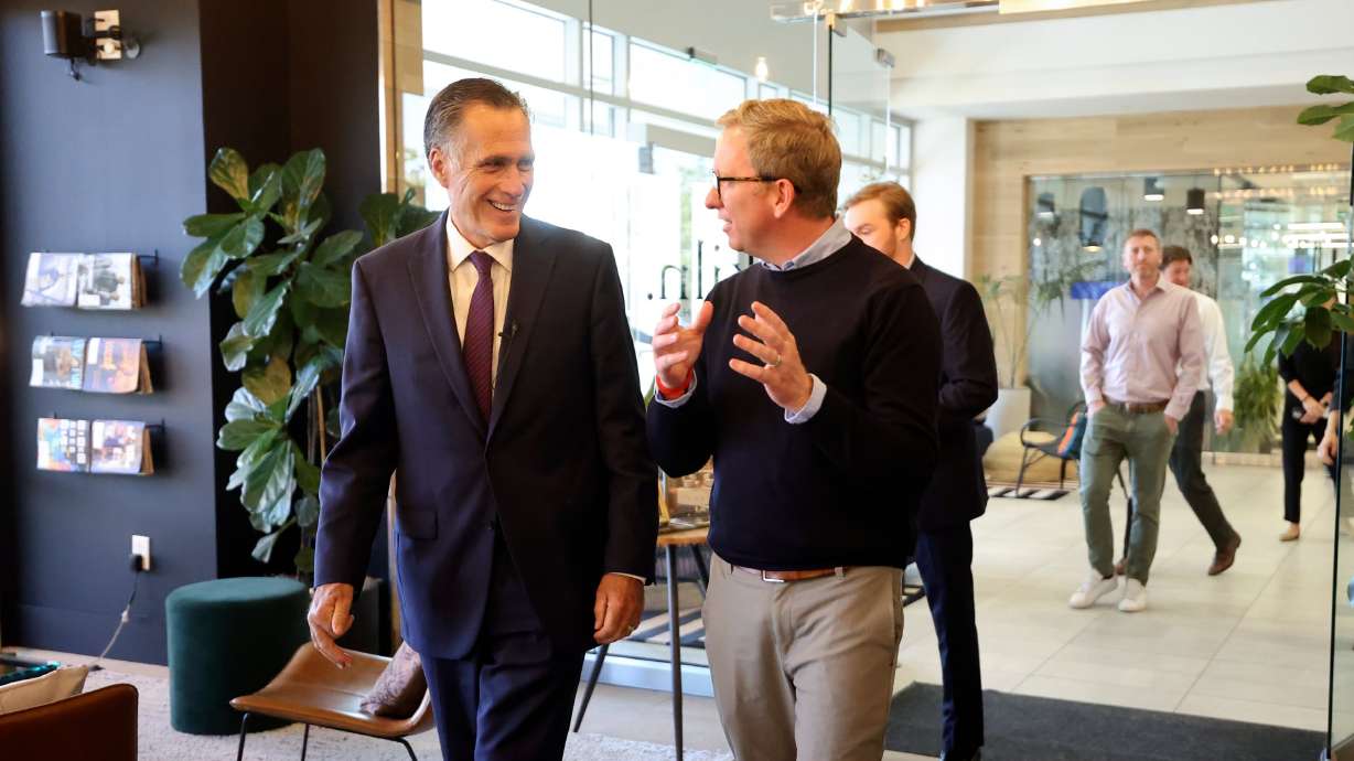 Sen. Mitt Romney, R-Utah, walks into Kiln with Arian Lewis, Kiln CEO, to meet with business leaders and entrepreneurs in Lehi on Tuesday. Romney says he is optimistic about America's future.