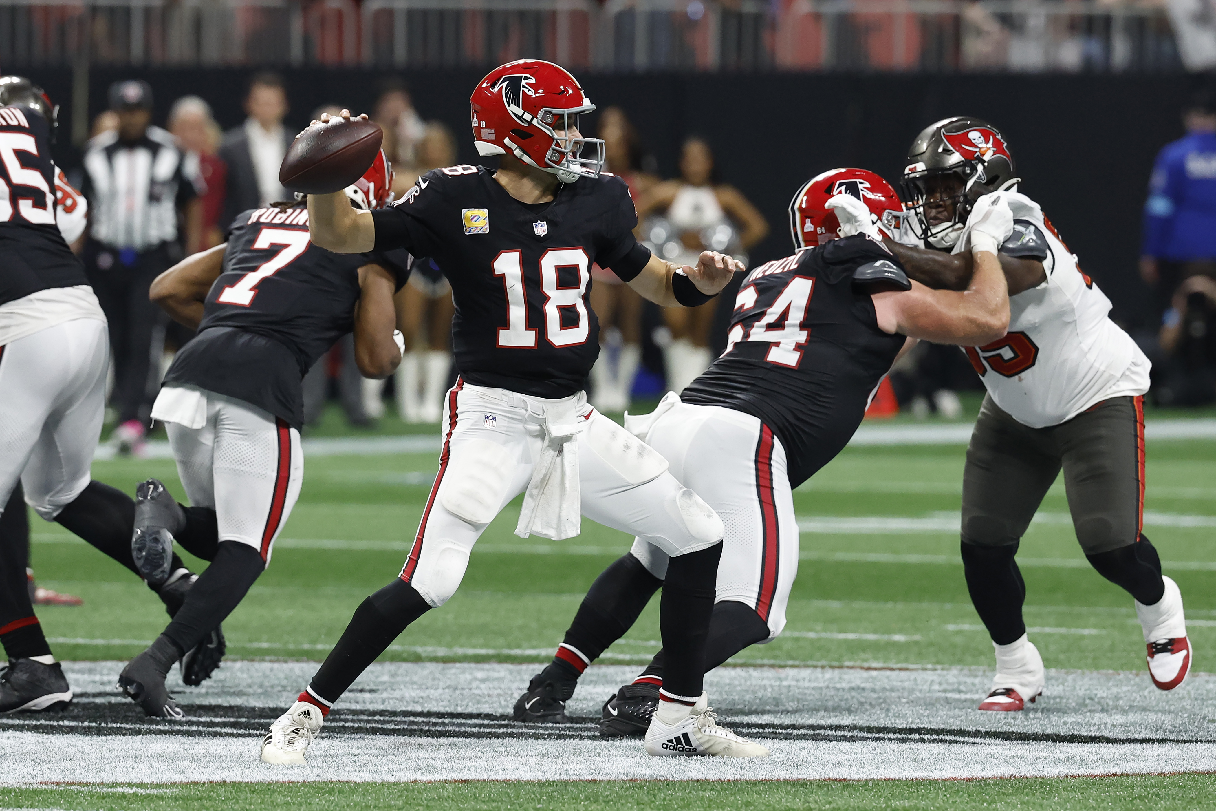 Atlanta Falcons quarterback Kirk Cousins (18) throws the game-wining touchdown pass to wide receiver KhaDarel Hodge (12) against the Tampa Bay Buccaneers during overtime in an NFL football game Thursday, Oct. 3, 2024, in Atlanta.