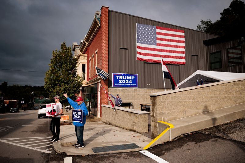 Supporters of Republican presidential nominee and former President Donald Trump hold signage in Union City, Pa., Sept. 24.