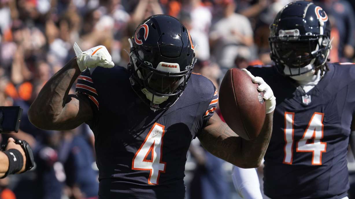 Chicago Bears running back D'Andre Swift (4) celebrates his one-yard touchdown against the Carolina Panthers during the first half of an NFL football game Sunday, Oct. 6, 2024, in Chicago.