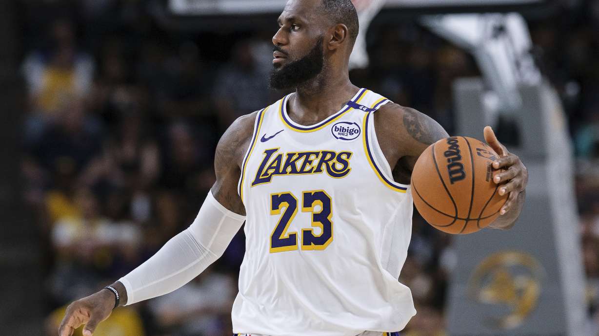 Los Angeles Lakers forward LeBron James (23) dribbles the ball during the first half of a preseason NBA basketball game against the Phoenix Suns, Sunday, Oct. 6, 2024, in Palm Desert, Calif.