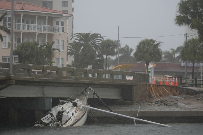 A boat damaged in Hurricane Helene rests against a bridge ahead of the arrival of Hurricane Milton, in South Pasadena, Fla., Wednesday.