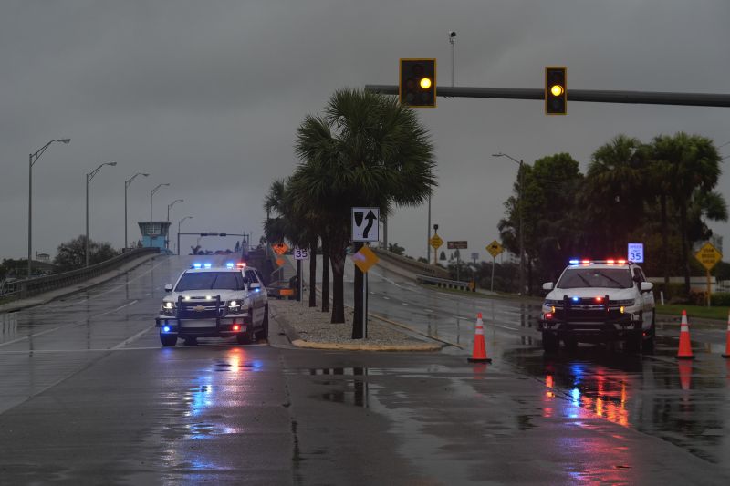 Police block off a bridge leading to the barrier island of St. Pete Beach, Fla., ahead of the arrival of Hurricane Milton, in South Pasadena, Fla., Wednesday.