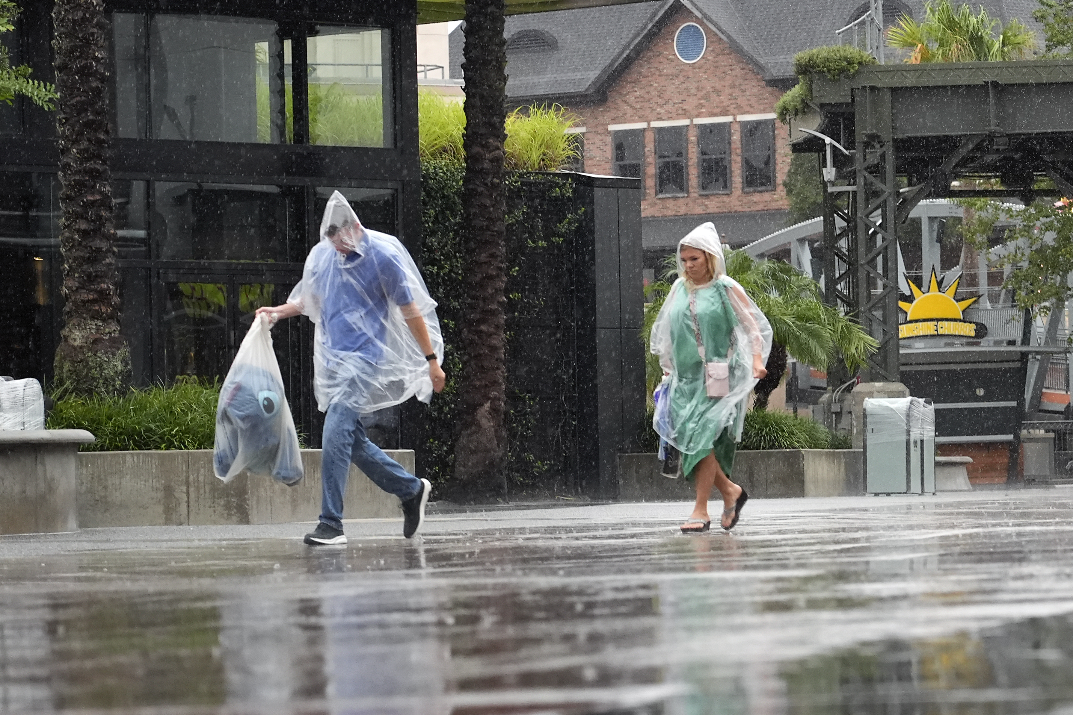 Tourists exit the Disney Springs entertainment complex before the arrival of Hurricane Milton Wednesday, Oct. 9, 2024, in Lake Buena Vista, Fla.
