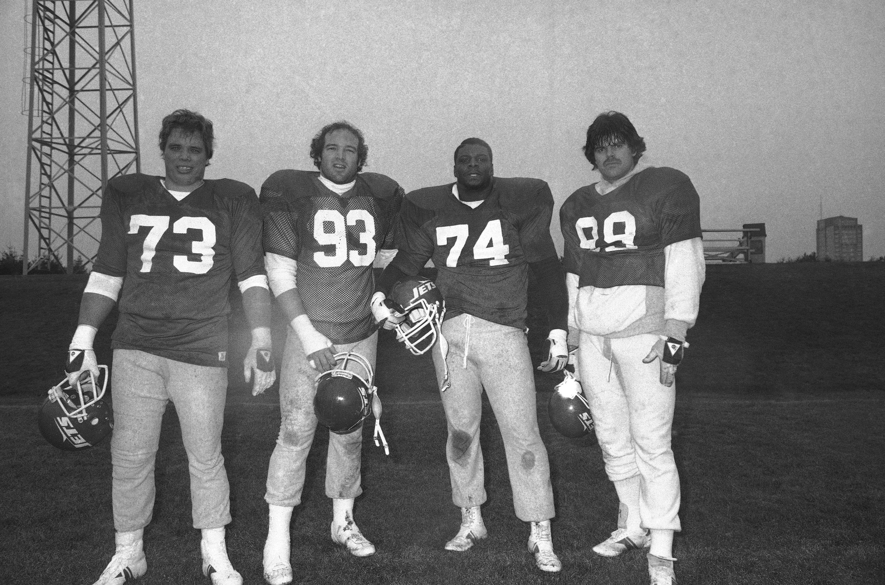 FILE - The New York Jets players, from left, defensive end Joe Klecko, defensive tackles Marty Lyons and Abdul Salaam, and defensive end Mark Gastineau, stand reunited during a team practice, Jan. 6, 1982, at the Jets training facility at Hofstra University in Hempstead, L.I.