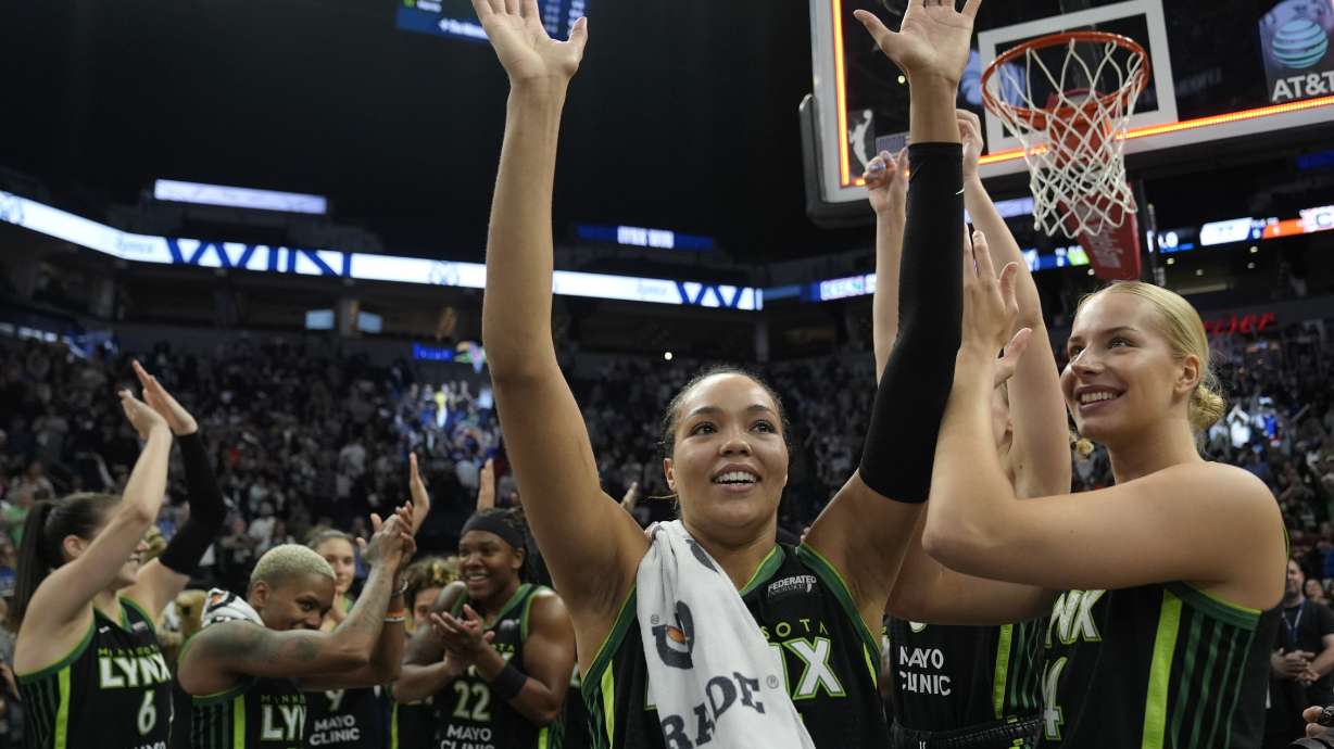 Minnesota Lynx forward Napheesa Collier, center, celebrates with teammates after the 88-77 win against the Connecticut Sun of Game 5 of a WNBA basketball semifinals, Tuesday, Oct. 8, 2024, in Minneapolis.