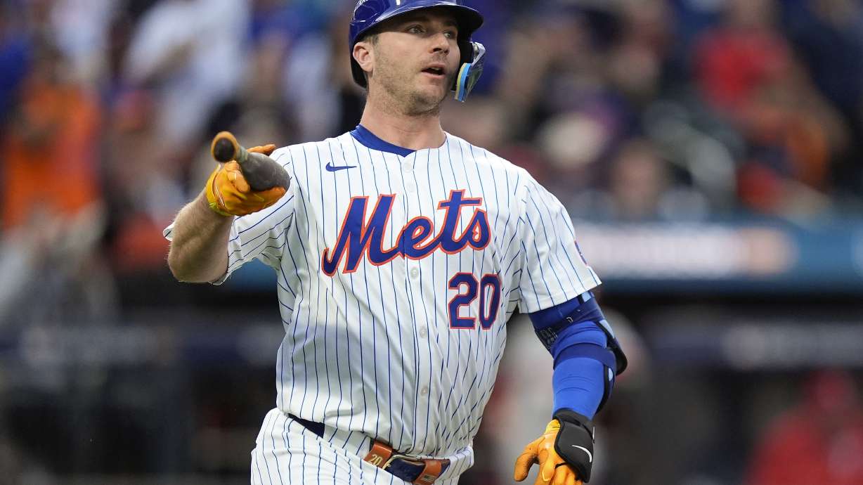 New York Mets' Pete Alonso (20) tosses his bat as he watches his solo home run sail over the right field wall against the Philadelphia Phillies during the second inning of Game 3 of the National League baseball playoff series, Tuesday, Oct. 8, 2024, in New York.