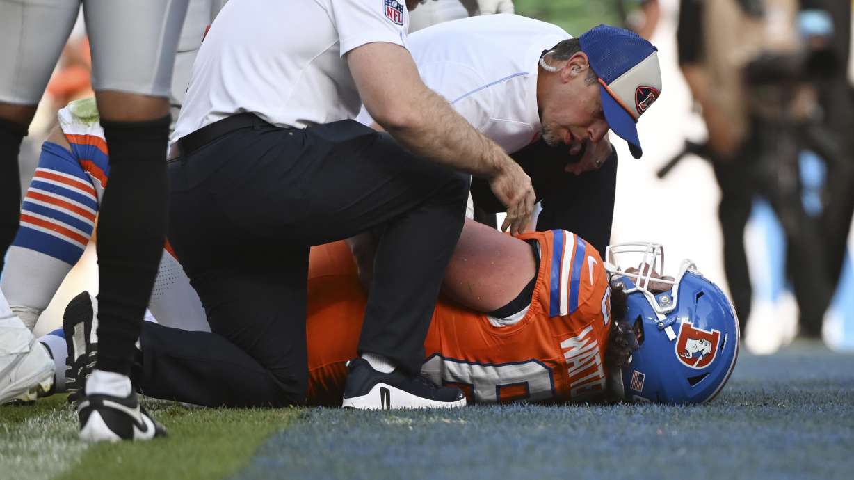 Denver Broncos center Luke Wattenberg is attended to during the second half of an NFL football game against the Las Vegas Raiders, Sunday, Oct. 6, 2024, in Denver.