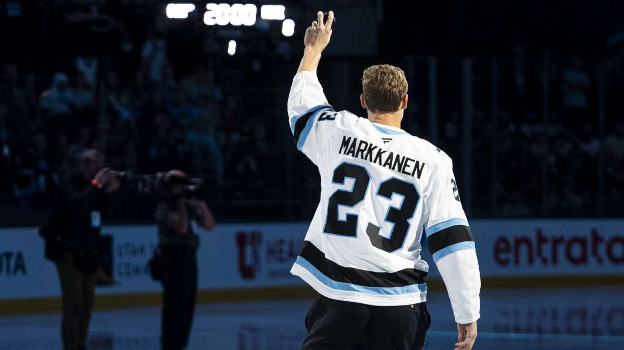 Utah Jazz power forward Lauri Markkanen delivers the game puck before a game between the Utah Hockey Club and the Chicago Blackhawks at the Delta Center in Salt Lake City on Tuesday, Oct. 8, 2024.