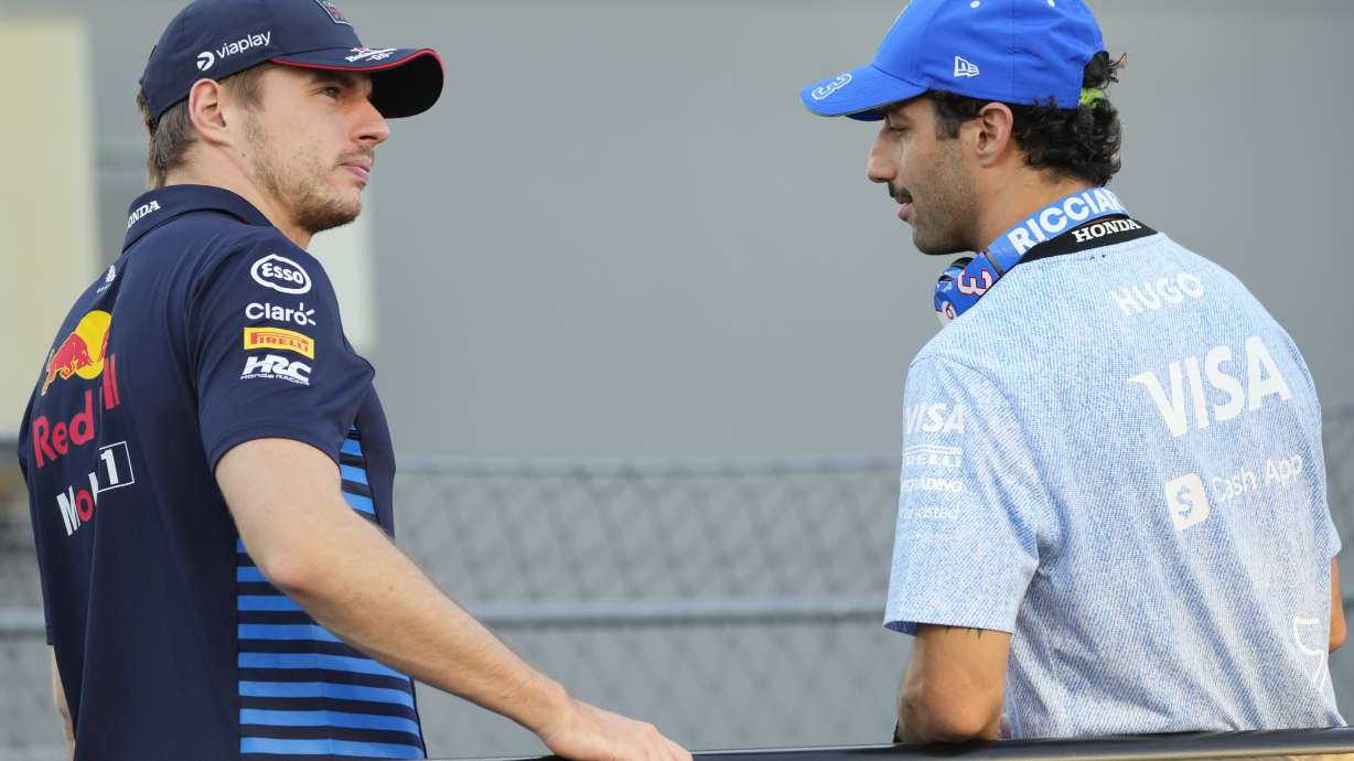 Red Bull driver Max Verstappen, left, of the Netherlands and RB driver Daniel Ricciardo of Australia talk during the drivers parade ahead of the Singapore Formula One Grand Prix at the Marina Bay Street Circuit, in Singapore, Sunday, Sept. 22, 2024.