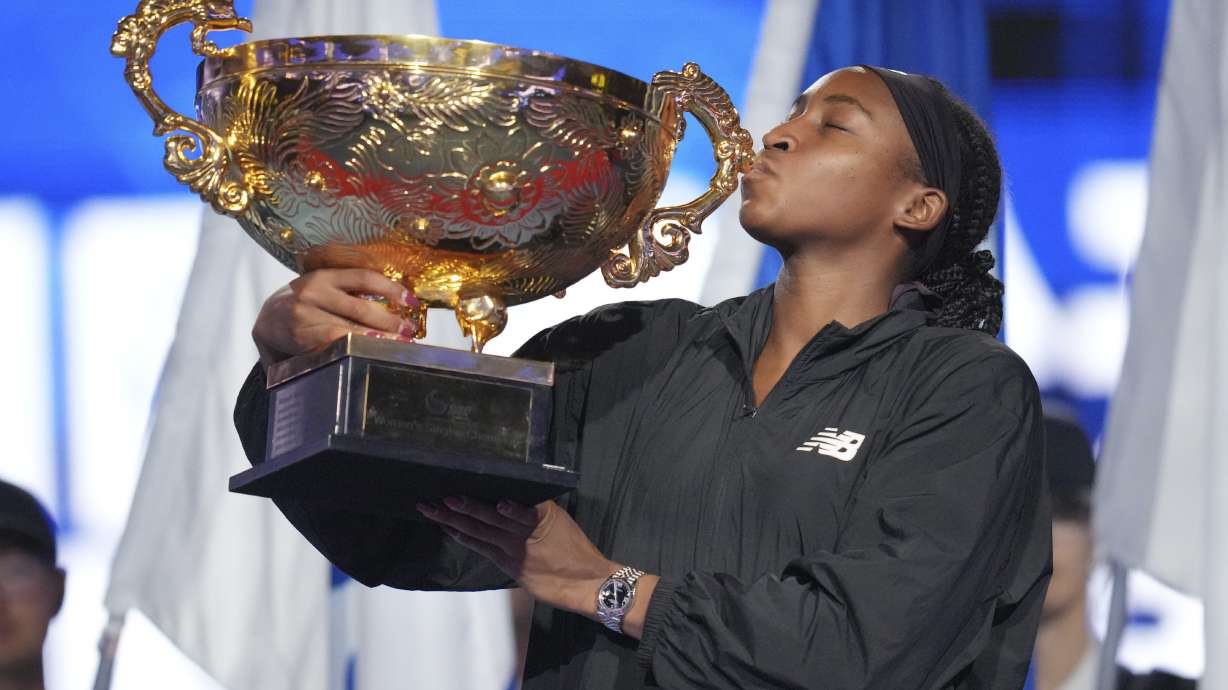 Coco Gauff of the United States kisses the trophy after defeating Karolina Muchova of Czech Republic in the women's singles final match at the China Open tennis tournament at the National Tennis Center in Beijing, Sunday, Oct. 6, 2024.