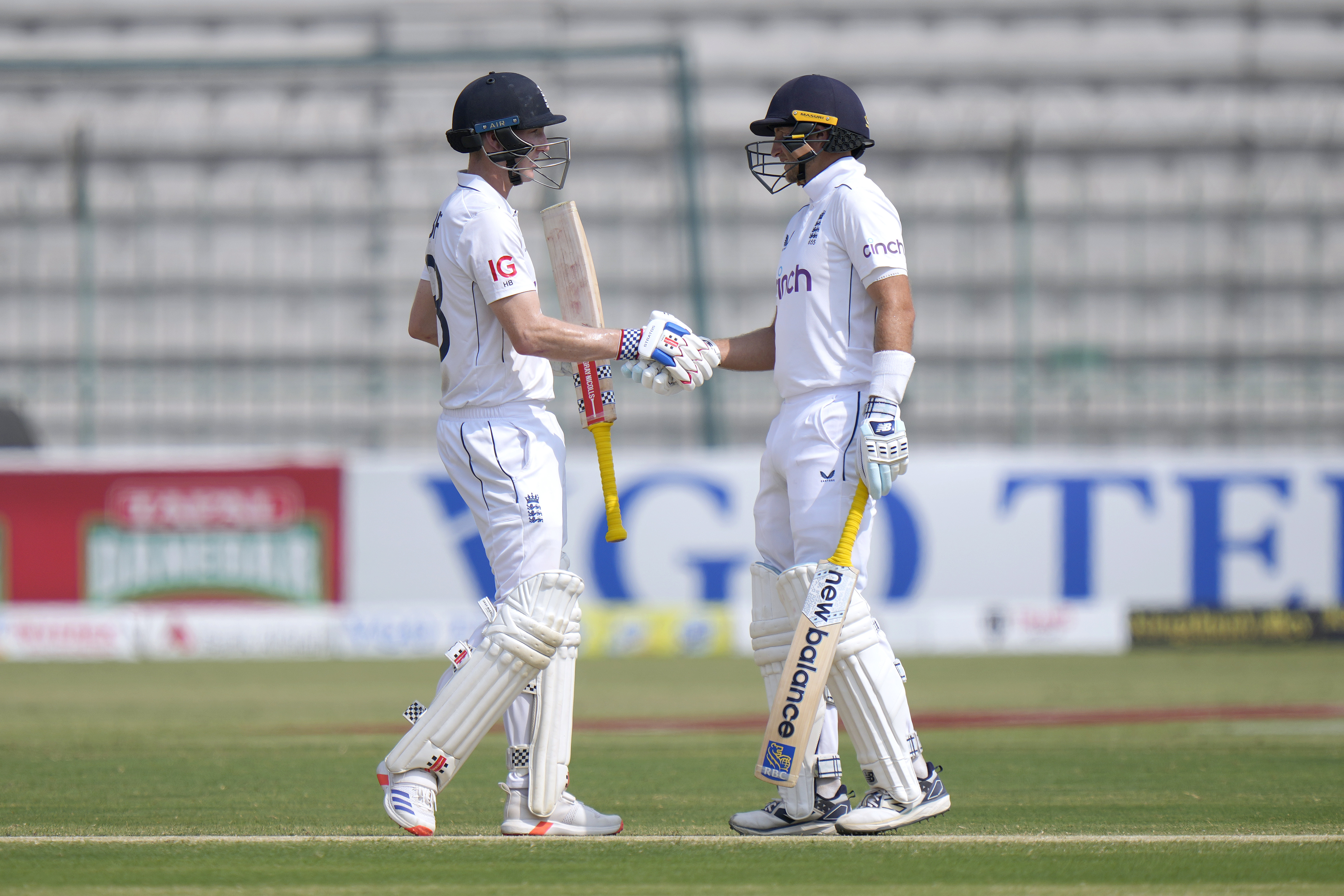 England's Harry Brook, left, shakes hand with Joe Root after scoring 250 runs during the fourth day of the first test cricket match between Pakistan and England, in Multan, Pakistan, Thursday, Oct. 10, 2024.