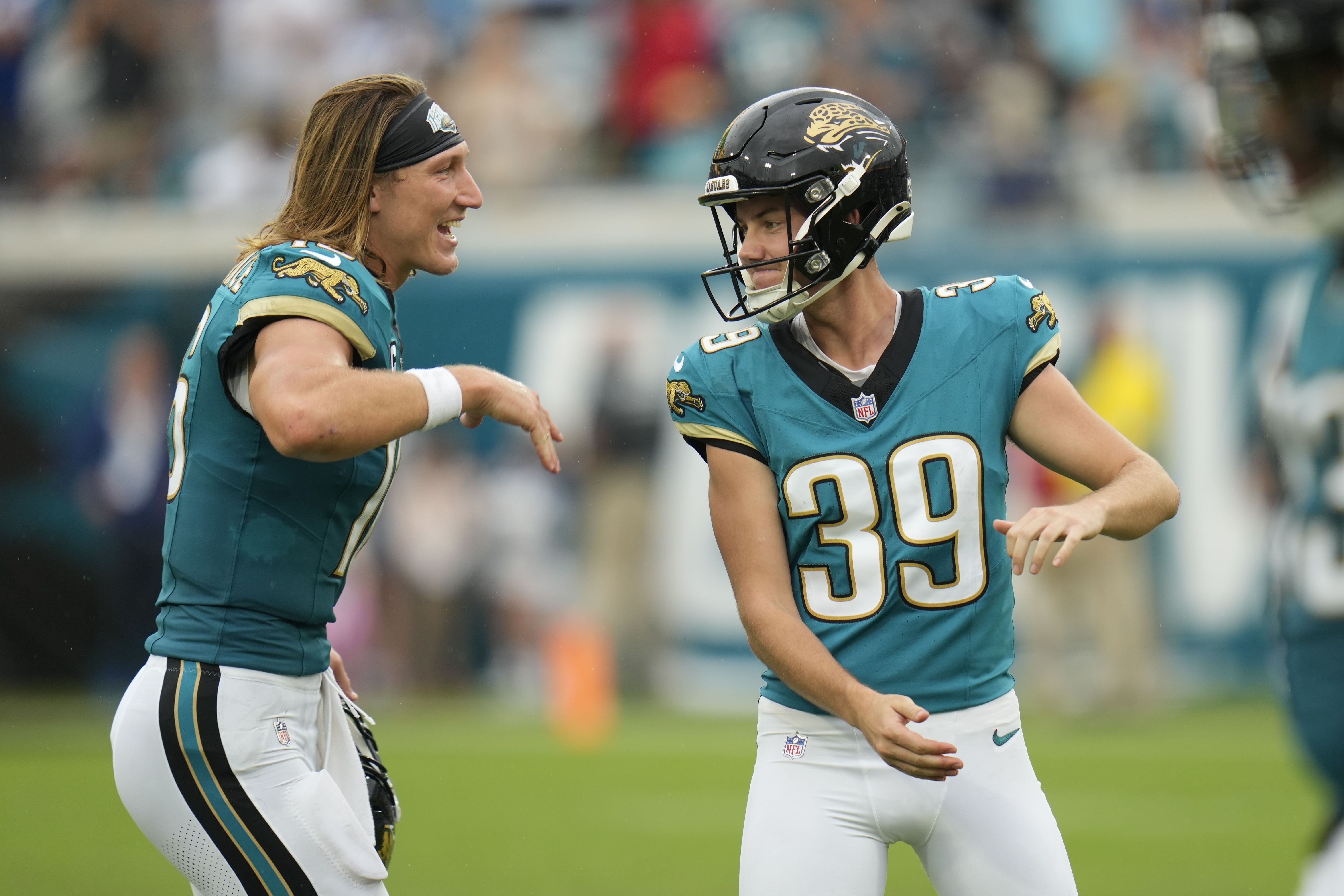 Jacksonville Jaguars place kicker Cam Little (39) celebrates with quarterback Trevor Lawrence (16) during the second half of an NFL football game against the Indianapolis Colts, Sunday, Oct. 6, 2024, in Jacksonville, Fla.