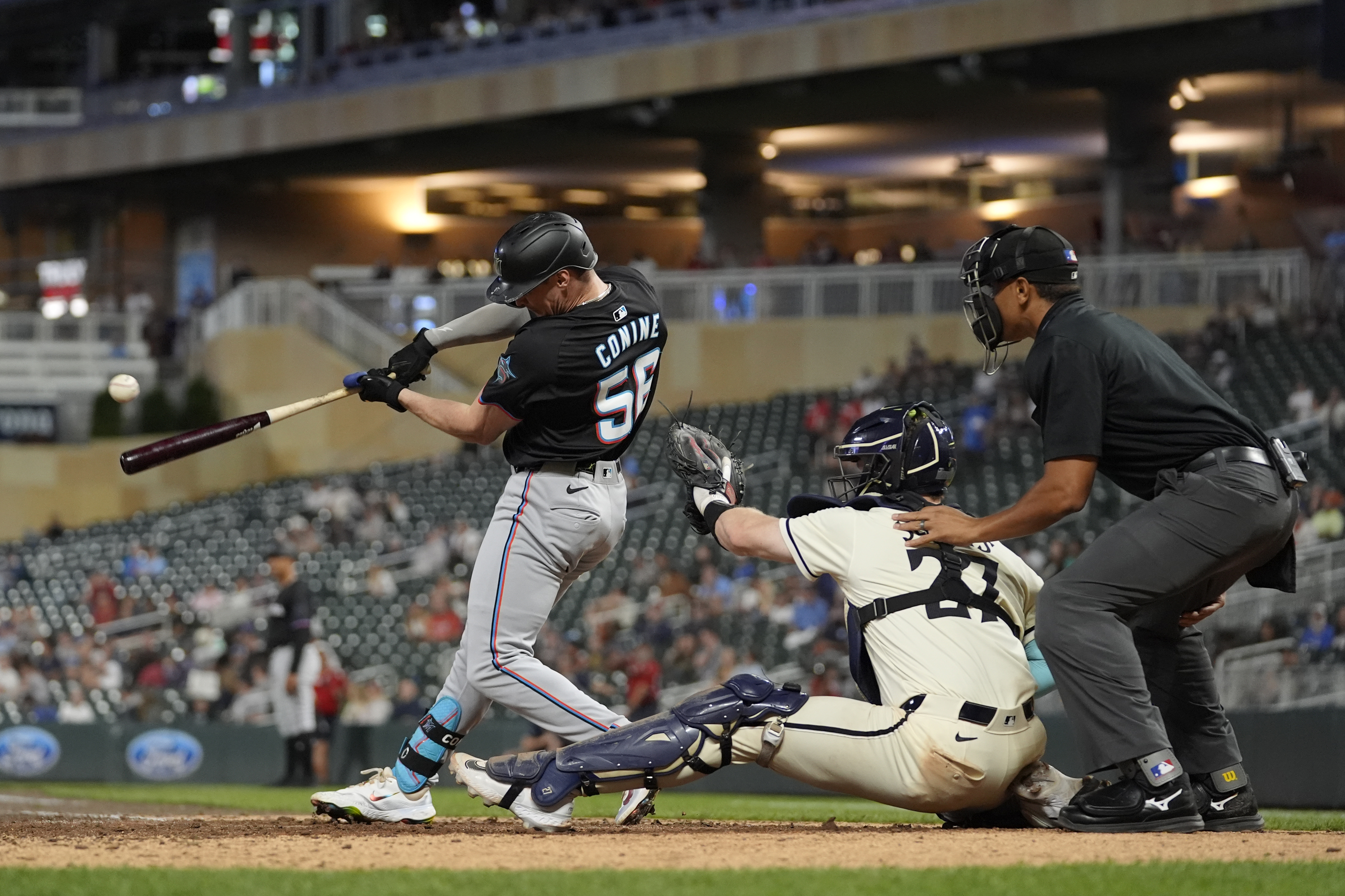 Miami Marlins' Griffin Conine (56) hits a two-run single during the 13th inning of a baseball game against the Minnesota Twins, Thursday, Sept. 26, 2024, in Minneapolis.