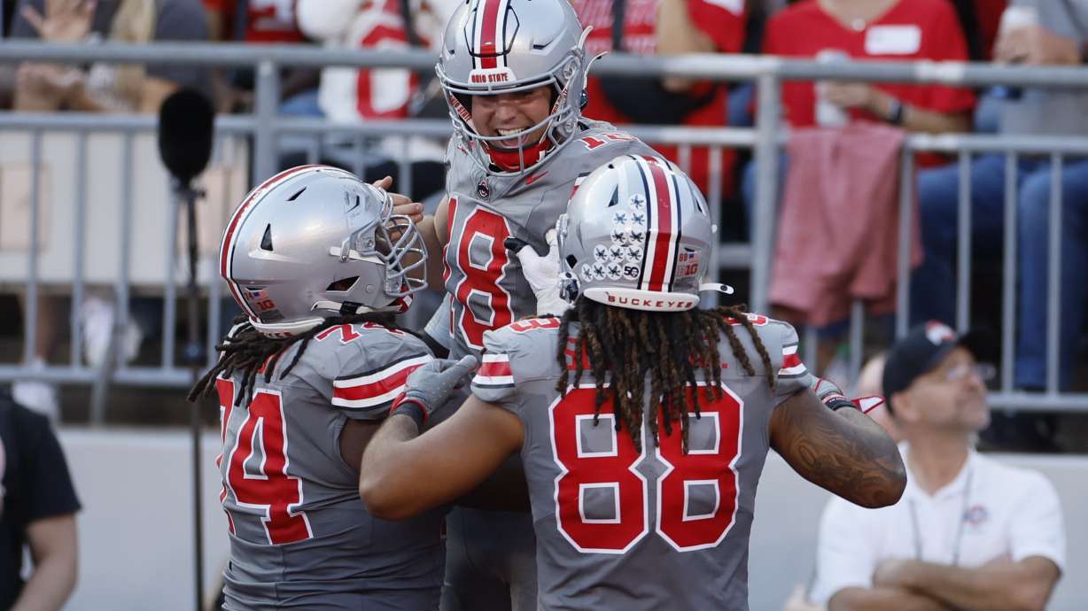 Ohio State quarterback Will Howard, center, celebrates his touchdown against Iowa during the second half of an NCAA college football game, Saturday, Oct. 5, 2024, in Columbus, Ohio.