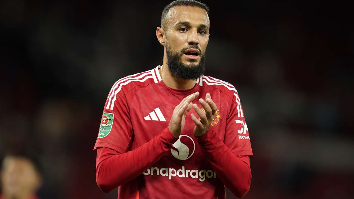 Manchester United's Noussair Mazraoui celebrates with supporters after winning the English League Cup soccer match between Manchester United and Barnsley at Old Trafford, Manchester, England, Tuesday, Sept. 17, 2024.