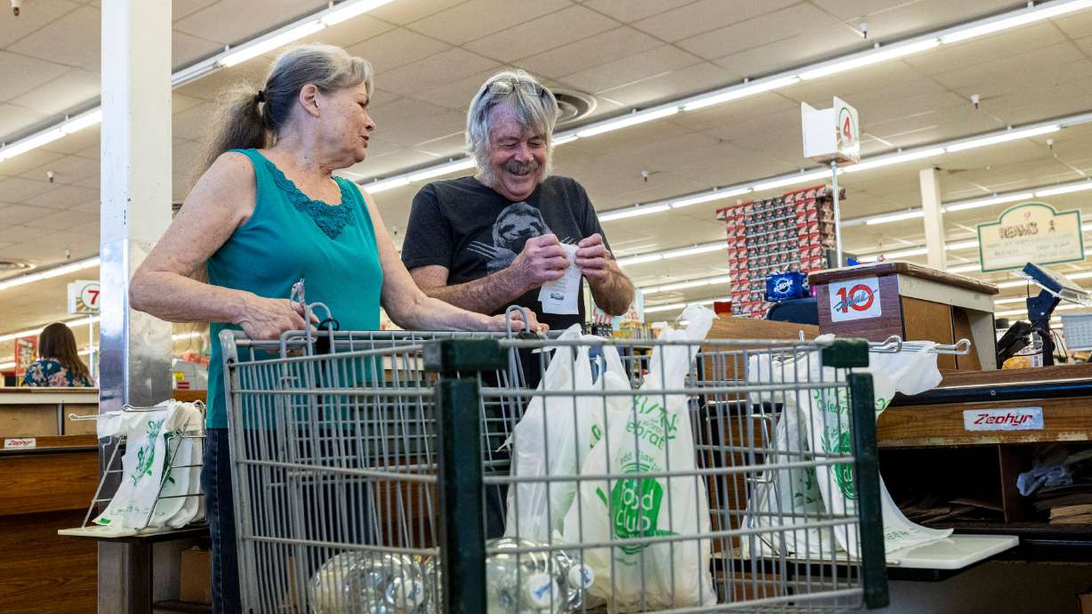 Greg Stewart folds his receipt after he and his wife, Susan Stewart, both of Cottonwood Heights, finished shopping at Ream’s in Sandy on Aug. 13. Prices on consumer goods and services rose at a 2.4% annual rate in September, a Thursday federal report found.