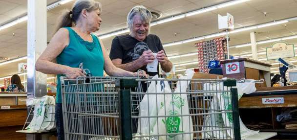 US inflation ticks down but jobless claims on the rise