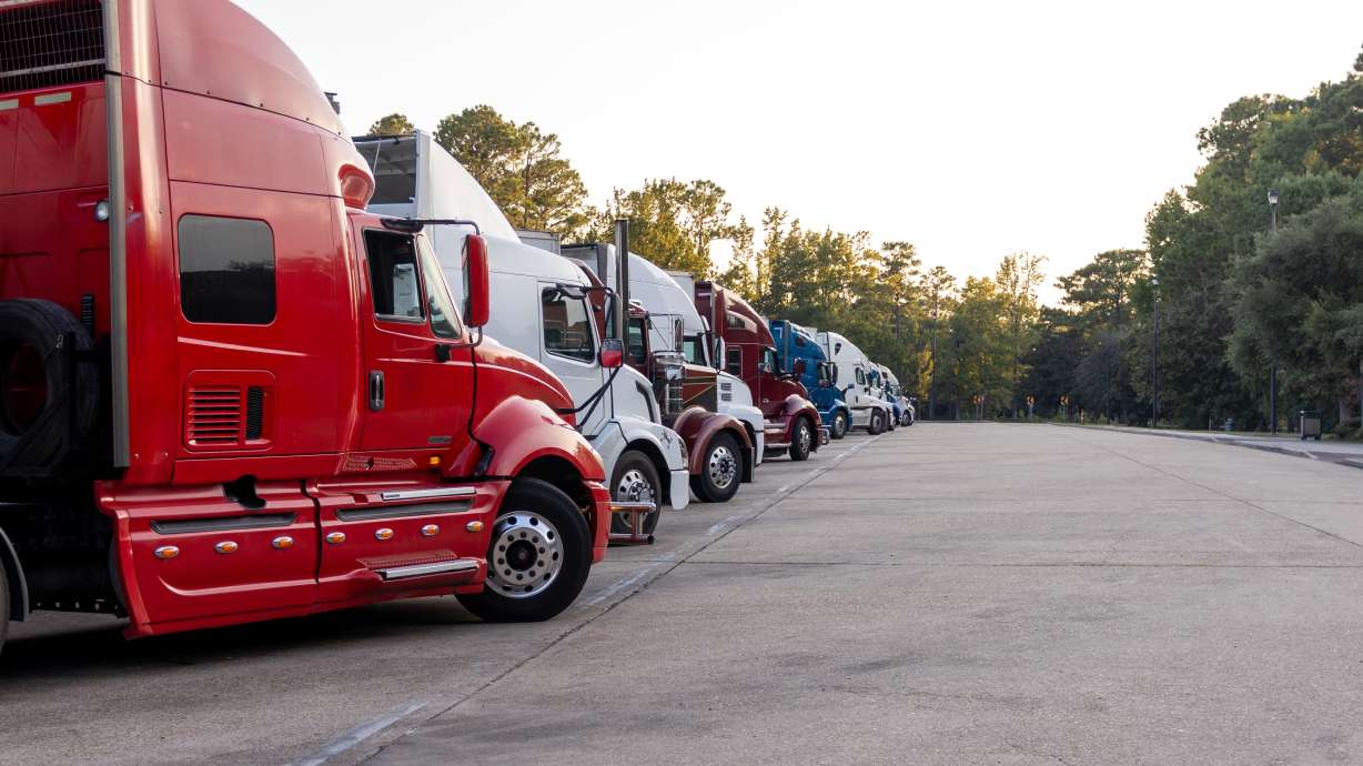 Two employees of a West Valley towing company have been charged with helping their boss illegally target and extort mostly minority semitruck drivers.