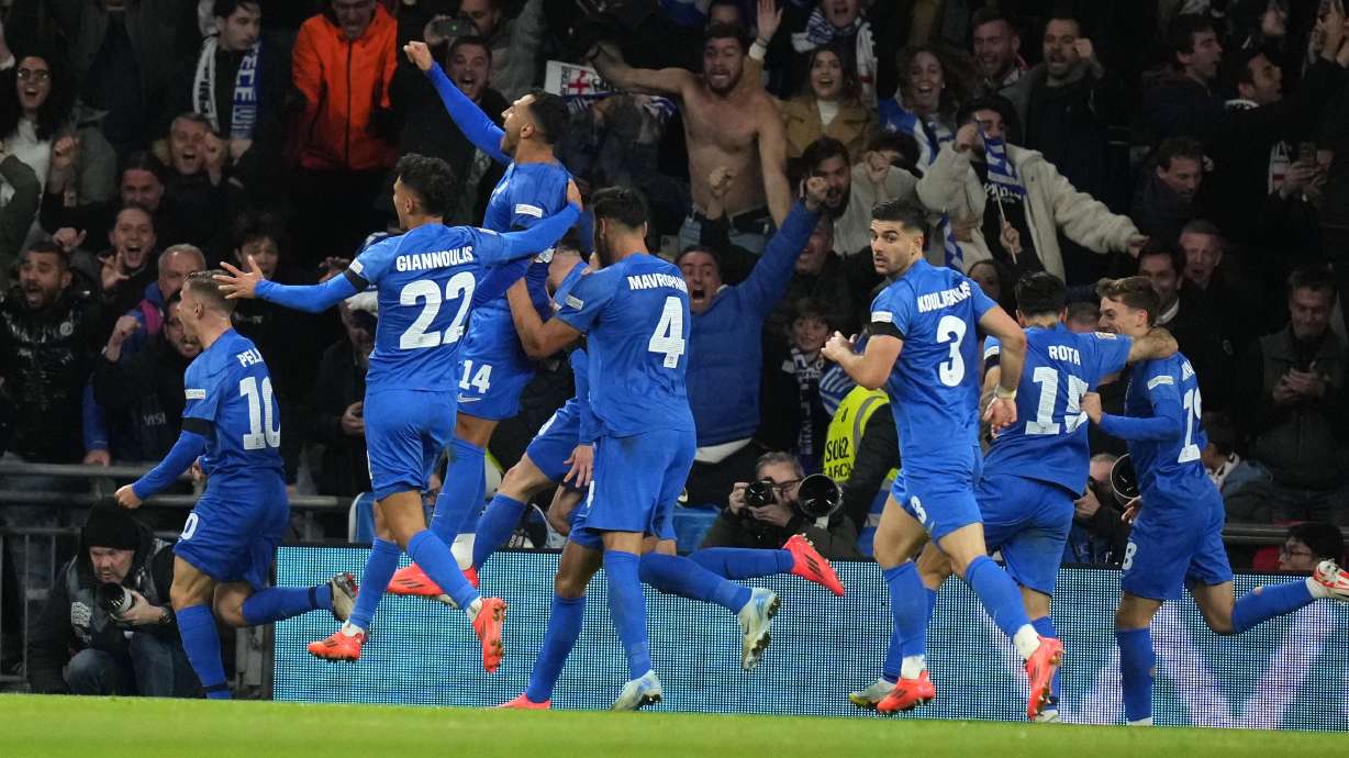 Greece's Vangelis Pavlidis, top, celebrates with teammates after scoring his side's second goal during the UEFA Nations League Group F soccer match between England and Greece at Wembley Stadium in London, Thursday, Oct. 10, 2024.