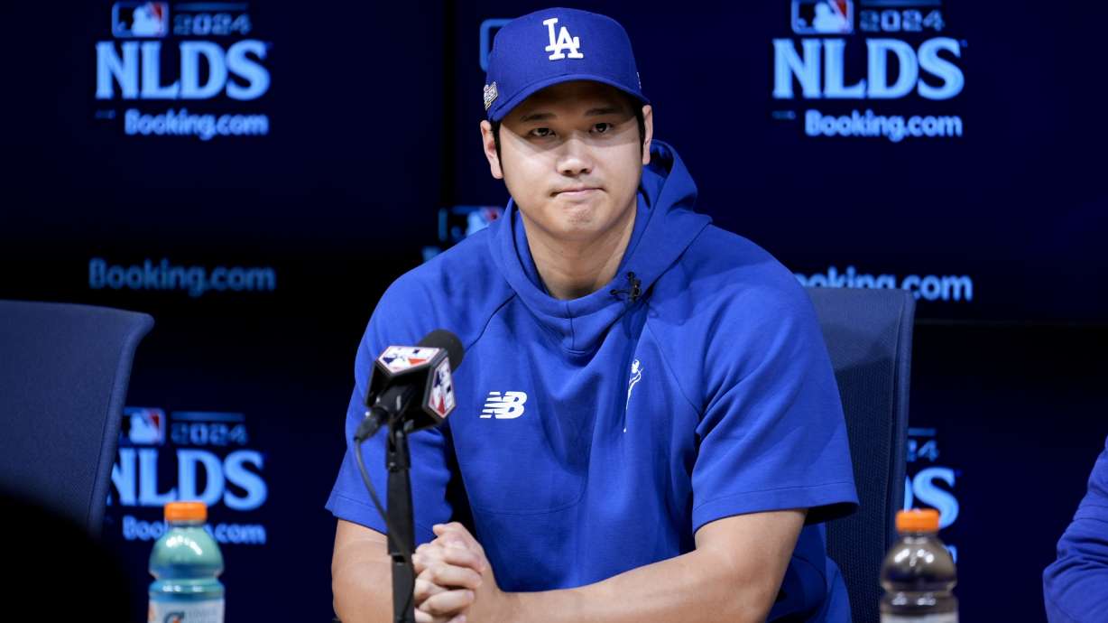 Los Angeles Dodgers' Shohei Ohtani fields questions ahead of Game 5 of a baseball National League Division Series against the San Diego Padres, Thursday, Oct. 10, 2024, in Los Angeles.