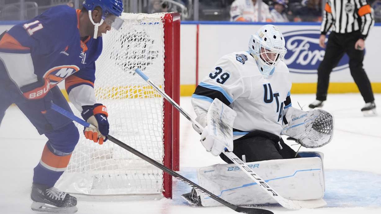 Utah Hockey Club goaltender Connor Ingram (39) stops a shot by New York Islanders' Anthony Duclair (11) during the second period of an NHL hockey game, Thursday, Oct. 10, 2024, in Elmont, N.Y.