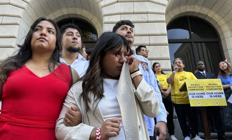 In New Orleans on Thursday, appellate judges heard arguments over a policy shielding certain immigrants from deportation. Wendy Reynoso, 24, whose immigration application remains in limbo, wipes away tears at a rally outside the court.