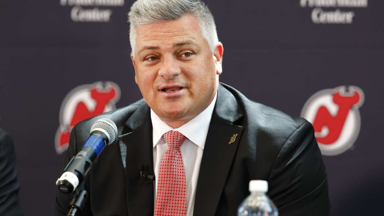 FILE - New Jersey Devils NHL hockey team new head coach Sheldon Keefe answers questions from reporters during press conference Tuesday, May 28, 2024, in Newark, N.J.