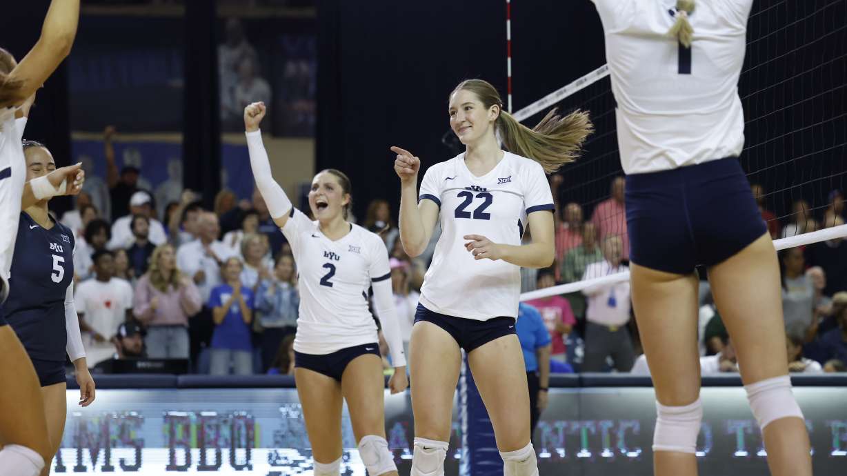 BYU outside hitter Elli Mortensen (2) and middle blocker Kjersti Strong (22) point at setter Alex Bower to celebrate a point against No. 18 Baylor, Thursday, Oct. 10, 2024 in the Smith Fieldhouse in Provo.