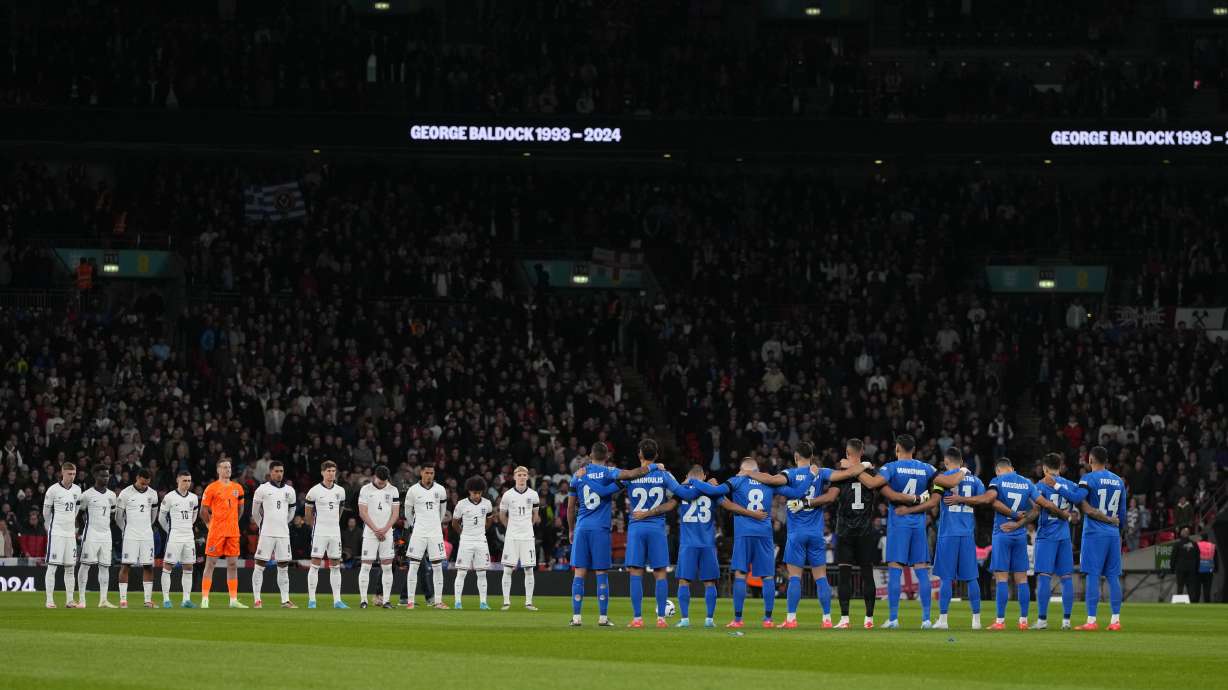 Teams hold a period of silence in tribute to George Baldock before the UEFA Nations League Group F soccer match between England and Greece at Wembley Stadium in London, Thursday, Oct. 10, 2024. England-born Greece international and Panathinaikos defender George Baldock, who had previously played for Sheffield United, has been found dead in his Athens home on Wednesday.