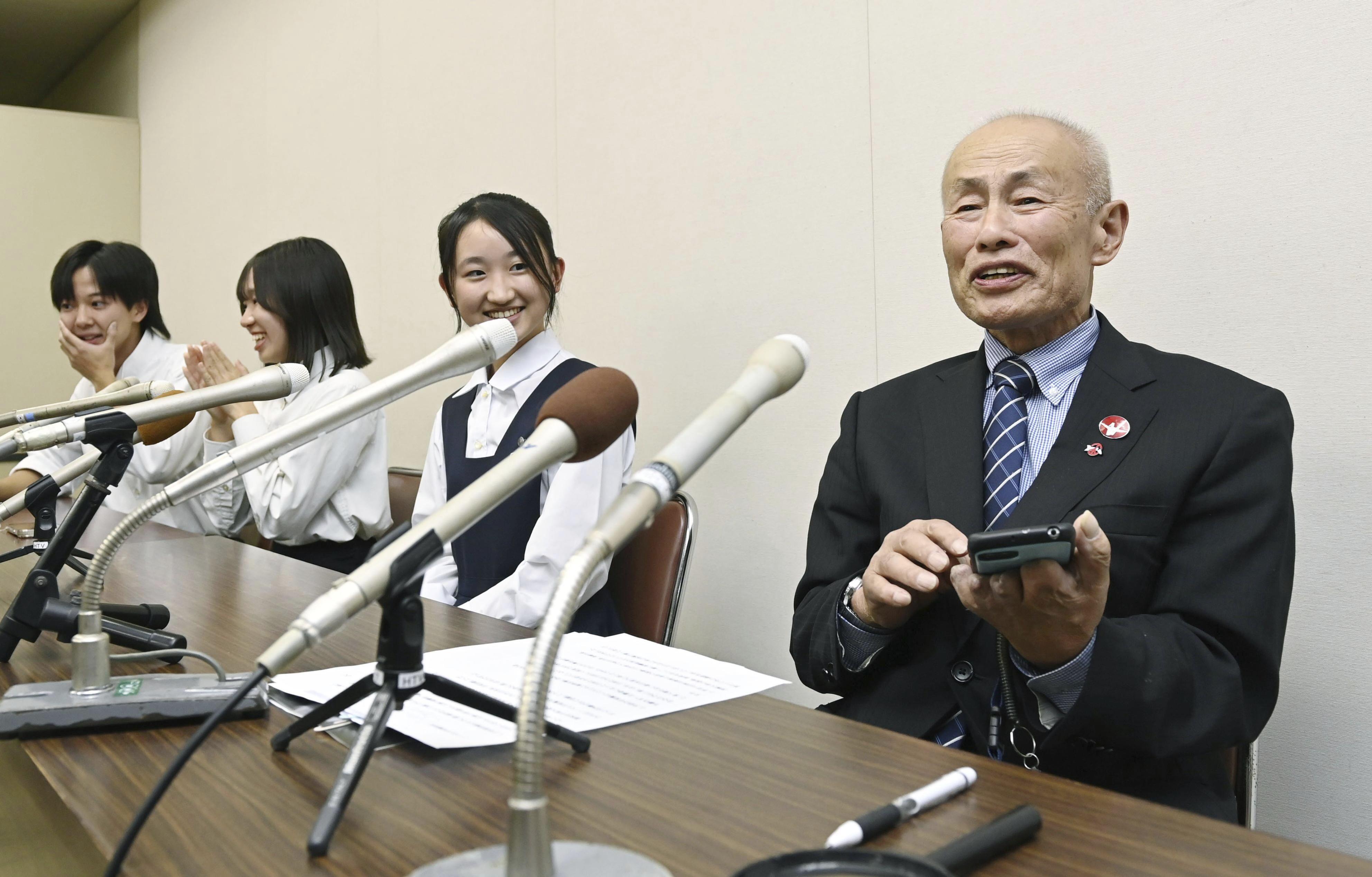 Toshiyuki Mimaki, right, president of Nihon Hidankyo, or the Japan Confederation of A- and H-Bomb Sufferers Organizations, speaks to media members in Hiroshima, Japan, Friday, as he reacts to Ninon Hidankyo's winning the Nobel Peace Prize.