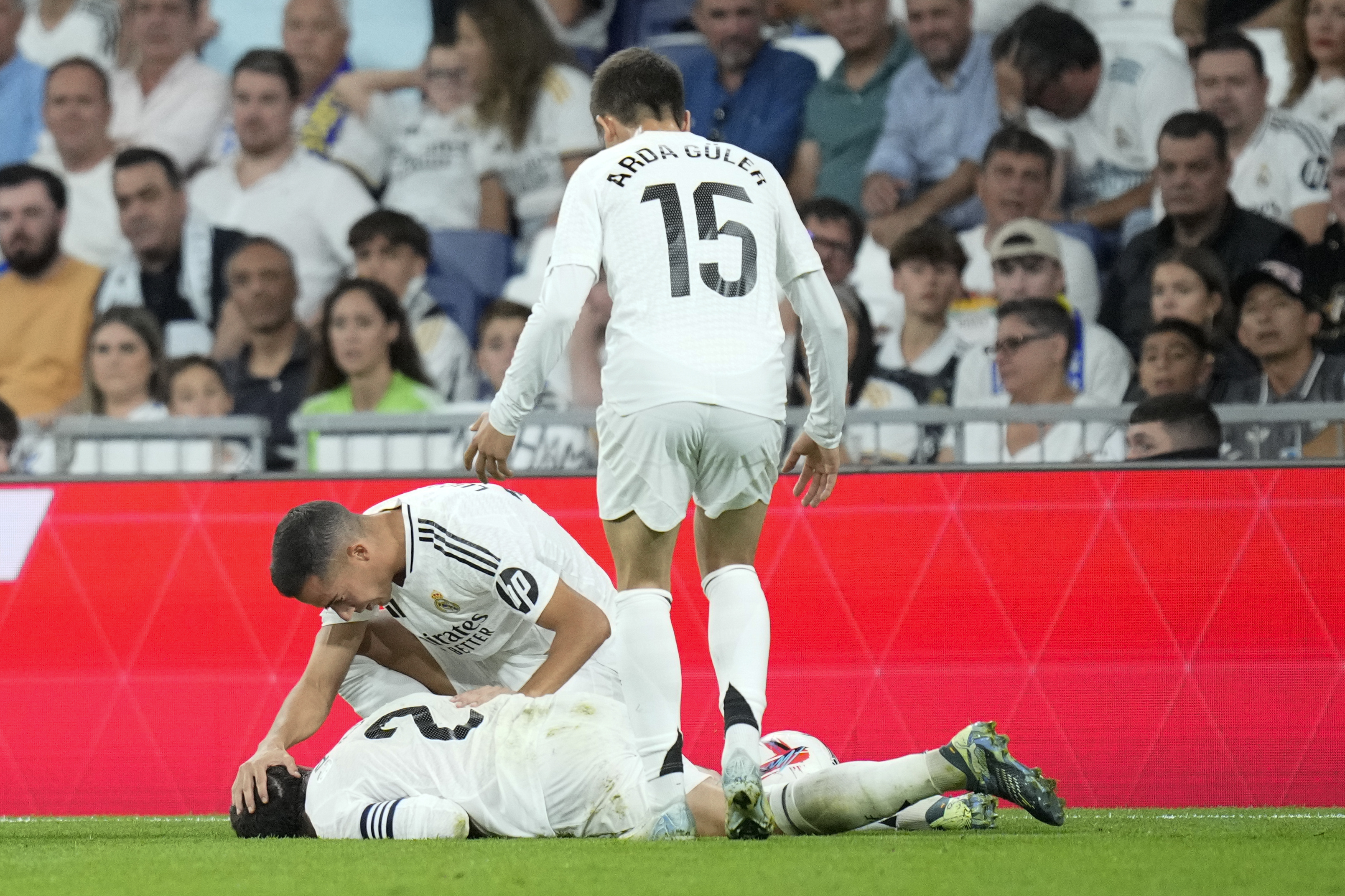 Real Madrid's Lucas Vazquez checks on his teammate Dani Carvajal during the La Liga soccer match between Real Madrid and Villareal in Madrid, Spain, on Saturday, Oct. 5, 2024.